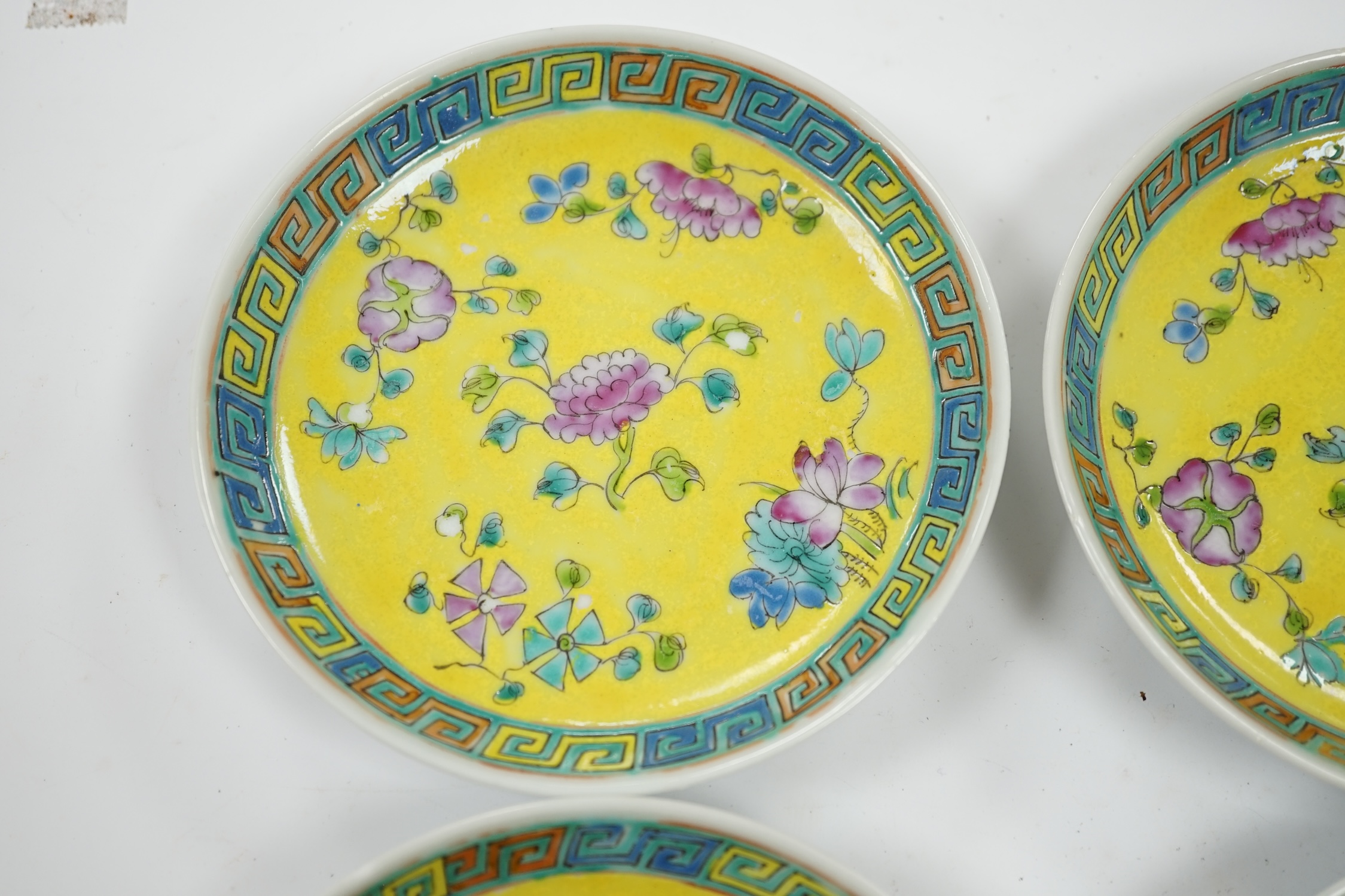 Four Chinese yellow ground saucer dishes, Republic period, 13.5cm diameter. Condition - good